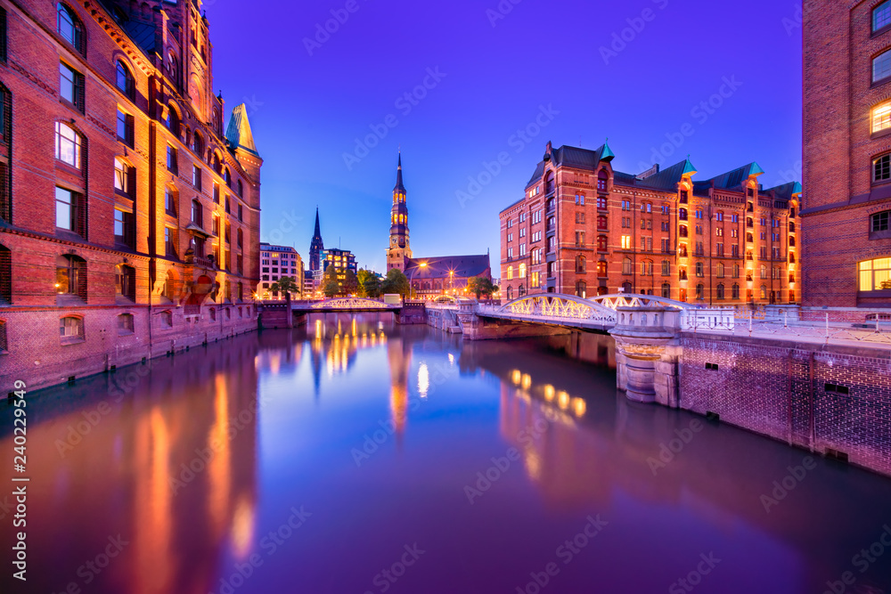 The Warehouse District (German: Speicherstadt) in Hamburg, Germany at night.  The largest warehouse district in the world is located in the port of Hamburg within the HafenCity quarter.
