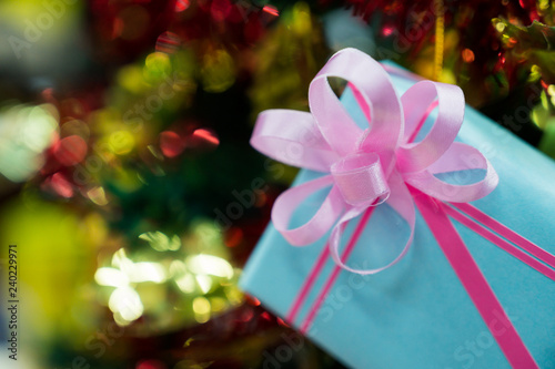 gift boxes decorated with Christmas tree on blurred background.
