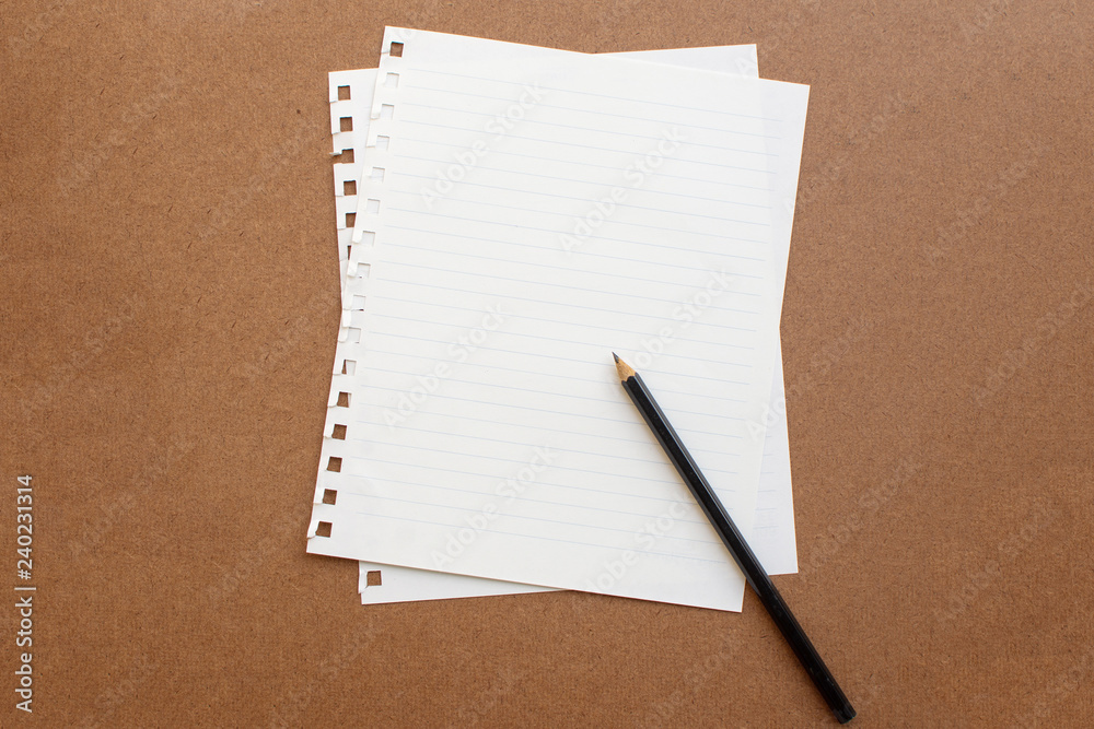 blank paper with black pencil on wooden background. soft focus. blank paper with black pencil on wooden background. soft focus.