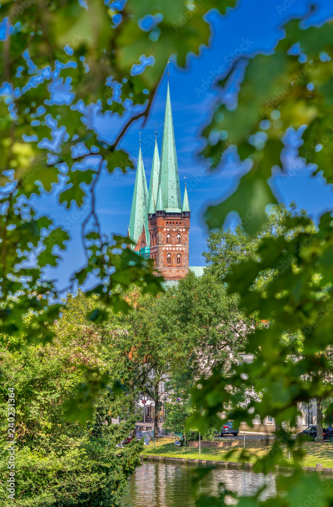 A view of the spires of the Luebeck Cathedral (German: Dom zu Lübeck, or Lübecker Dom) in Luebeck (German: Lübeck), Germany, across the river Trave.