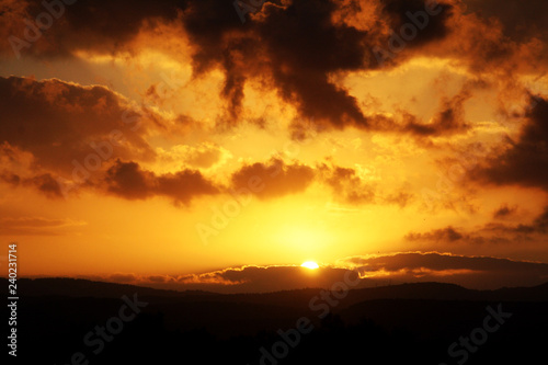 Cloudy sunset  above desert mountains © Tuvia