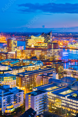 Aerial view of the harbor district and downtown Hamburg, Germany, at dusk.