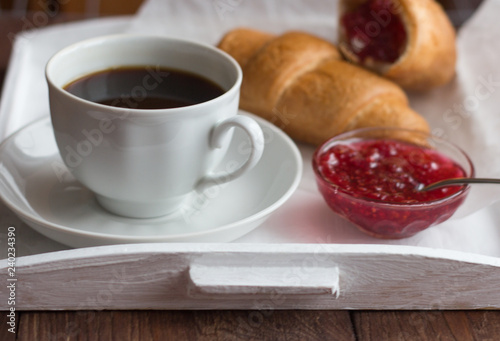 croissants with raspberry jam and black coffee