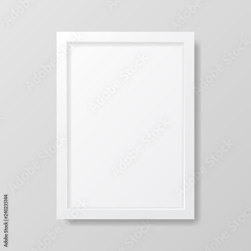 Realistic empty white picture frame, isolated on a neutral gray background. 