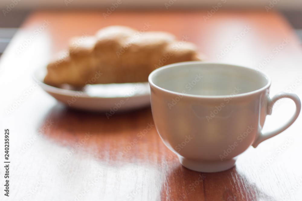 Fototapeta premium coffee Cup and croissant on the table