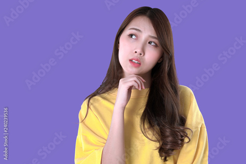 Asian woman decide for a new jobs, yellow t-shirt clothing, purple background
