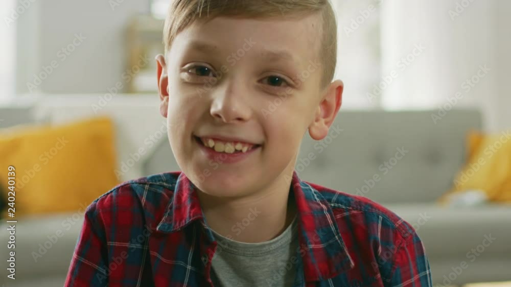 Portrait of Adorable Young Boy Smiling on Camera. In the Background Blurred Sunny Room. Portrait of Adorable Young Boy Smiling on Camera. In the Background Blurred Sunny Room.