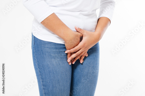 Young sick black woman with hands holding pressing her crotch lower abdomen. Medical or gynecological problems concept