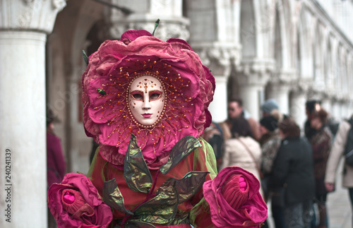 a colorful red costume for the Venice Carnival in Piazza San Marco