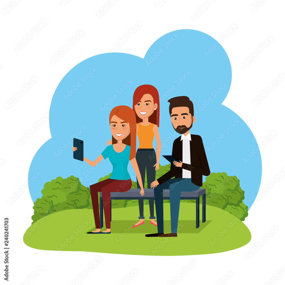 group of young people using smartphone in the park group of young people using smartphone in the park