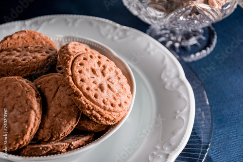 brown cookies on a white plate with side light