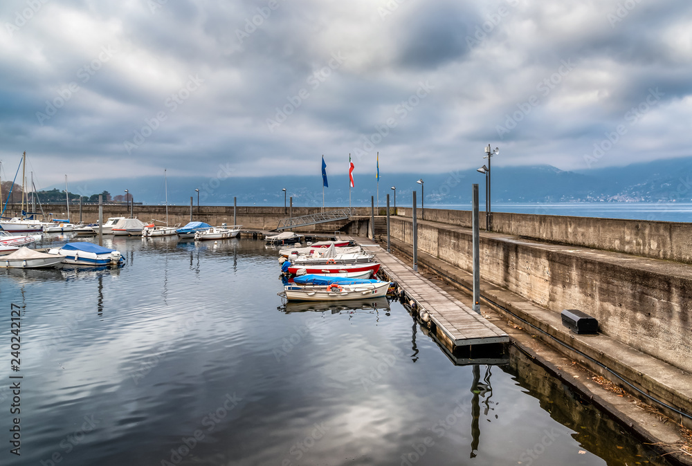 Fototapeta premium New Harbor of Luino on the Lake Maggiore in cloudy day, province of Varese, Italy