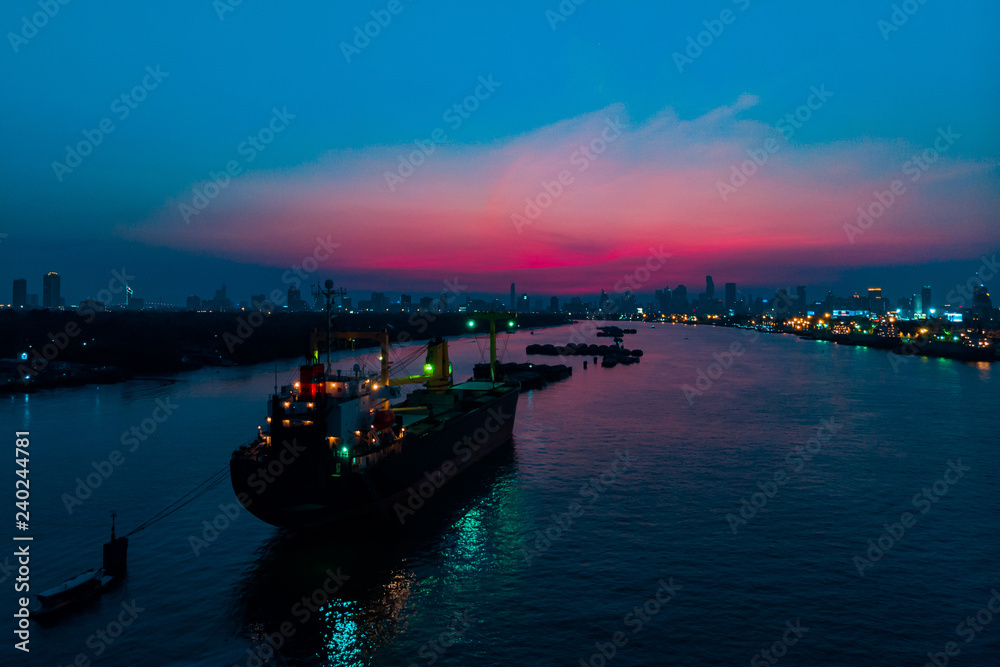 Container cargo ship in the ocean at twilight sky, Business International trade and Container logistics export-import harbor to the International port / Shipping Containers concept