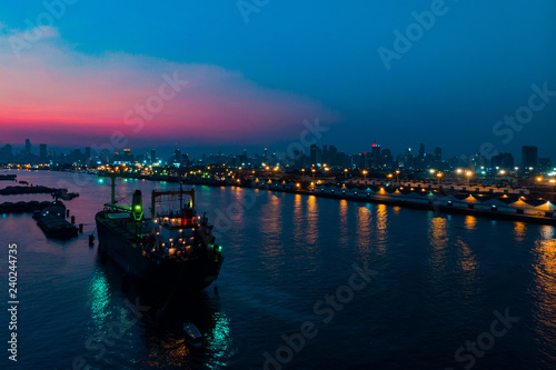 Container cargo ship in the ocean at twilight sky, Business International trade and Container logistics export-import harbor to the International port / Shipping Containers concept