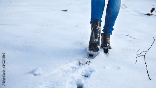 female feet leave footprints in the snow