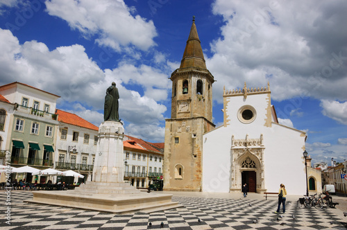 Main square of medieval town Tomar (Portugal). Church of Saint John the Baptist. Tourists. Cafe.