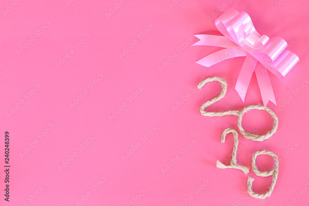 Happy New Year 2019 on pink wooden background