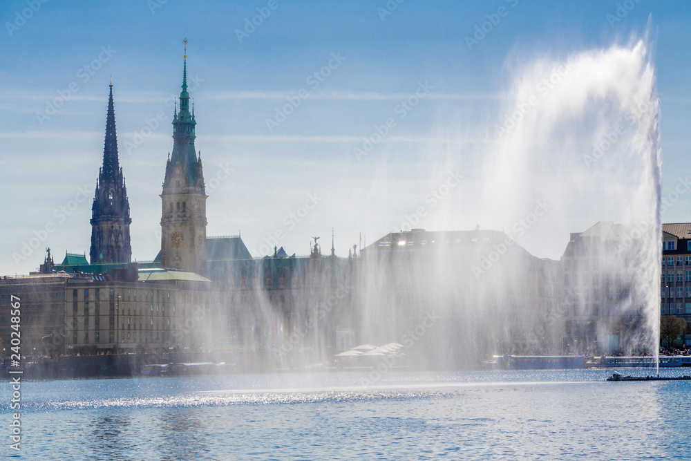 The lake Binnenalster with the fountain and a view of downtown Hamburg, Germany.