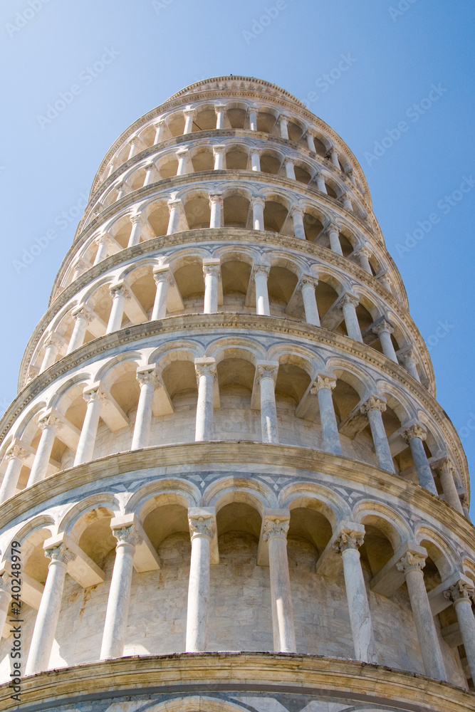 The Leaning Tower of Pisa from below with beautiful blue sky, Tuscany, Italy