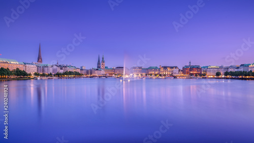 The Inner Alster Lake  German  Binnenalster  in Hamburg  Germany. Evening view of the inner city at dusk with the fountain reflecting in the water.