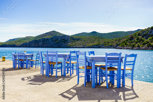 Open cafe outdoor restaurant in Greece on sea shore