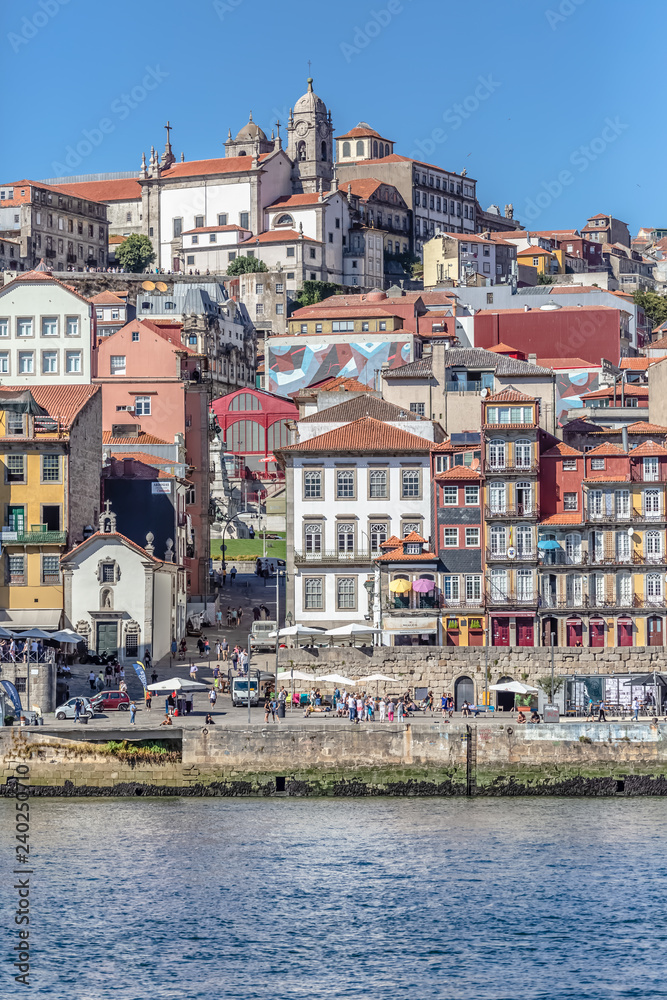 View of river Douro, with Rabelo boats on Ribeira docks, traditional downtown as background