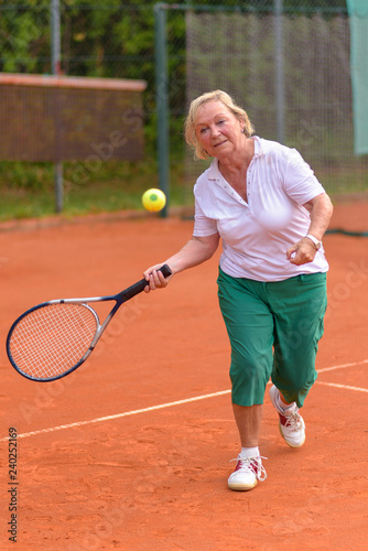 Senior woman playing tennis © michaelheim
