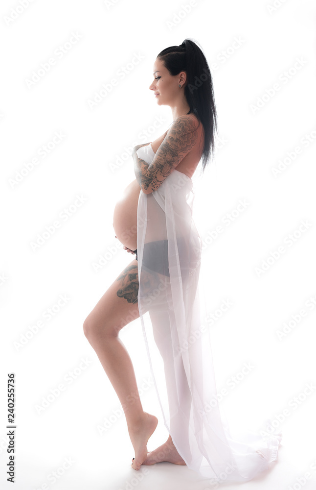 pregnant young woman with tattoo