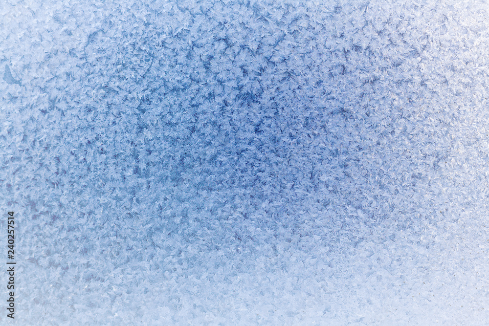 Winter blue background of snowflakes and frost