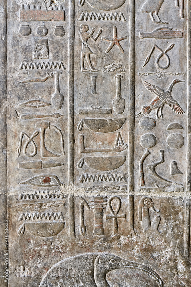 Ancient egyptian temple wall covered with hieroglyphics and imag