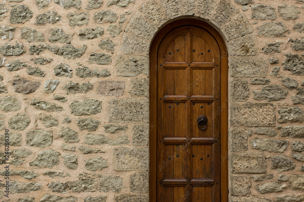 wooden arch door frame in medieval castle building stone wall