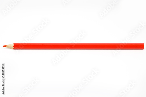 Simple sharpened red pencil made of wood on a white background. Isolated.