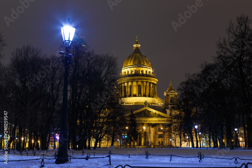 Saint Petersburg, Russia. St. Isaac's Cathedral in lights of the evening city. View from the Palace Square in St. Petersburg. Travel photo of the landmark.
