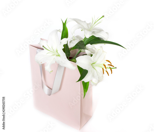 Fototapeta Naklejka Na Ścianę i Meble -  white lilies in a pink shopping bag