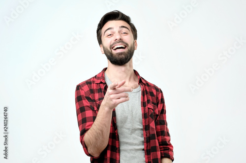 Spanish man mocking you or laughing on his friend joke. Studio shoot photo