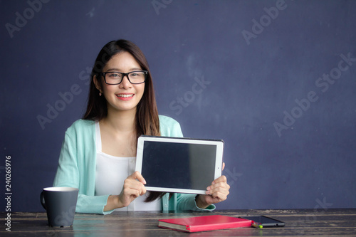 thai china adult office girl glasses white shirt show her tablet.