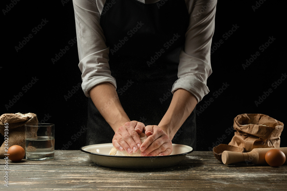 Cookery.The chef prepares the dough for pasta, pizza, bread, pancakes.Preparation and work with flour and dough.Delicious food, recipes, cooking, gastronomy, background for design Cookery.The chef prepares the dough for pasta, pizza, bread, pancakes.Preparation and work with flour and dough.Delicious food, recipes, cooking, gastronomy, background for design
