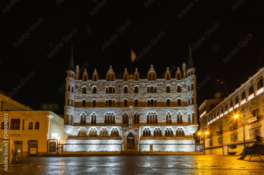Leon, Spain. Winter of 2018. Night view of the building designed by Gaudi in the city of Leon, Botines. It's a rainy night.