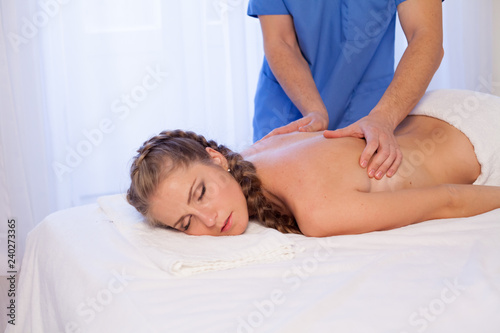 beautiful woman makes therapeutic massage therapist therapy Spa