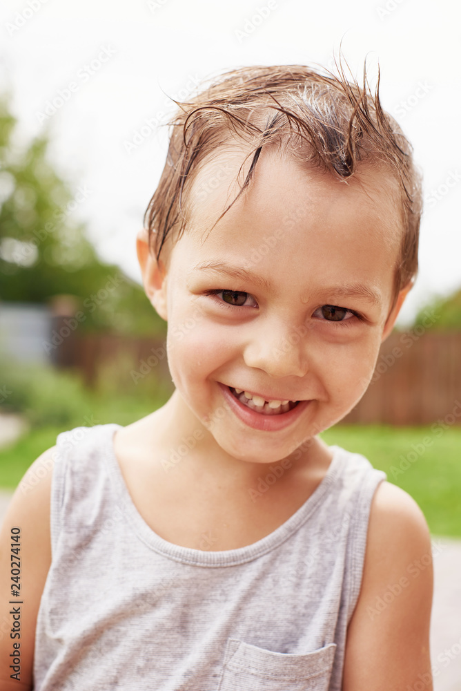 Little boy playing water splash in garden Little boy playing water splash in garden