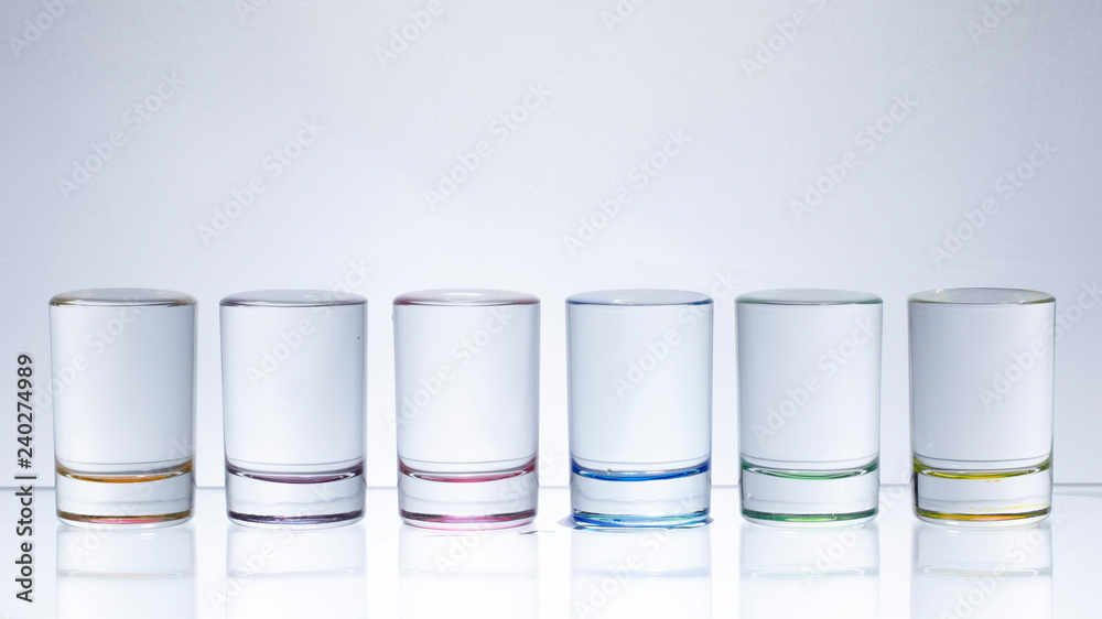 Six small multi-colored glasses on a bright background Six small multi-colored glasses on a bright background