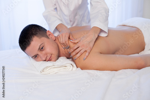 male massage therapist make therapeutic massage and body therapy Spa