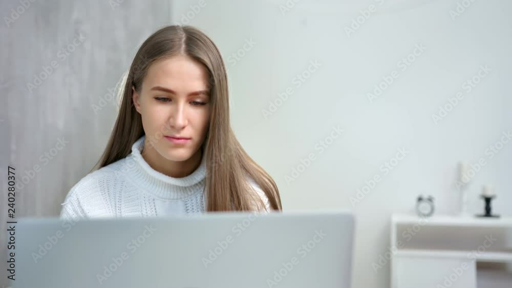 Medium close-up confident young busy female working at home using laptop pc Medium close-up confident young busy female working at home using laptop pc