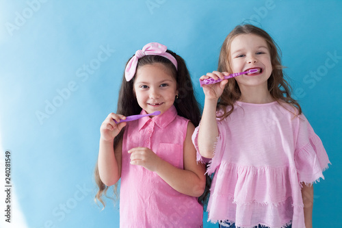 two beautiful small girls girlfriend sister in pink clothes
