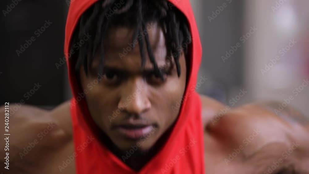 African american man making exercice on training apparatus in gym