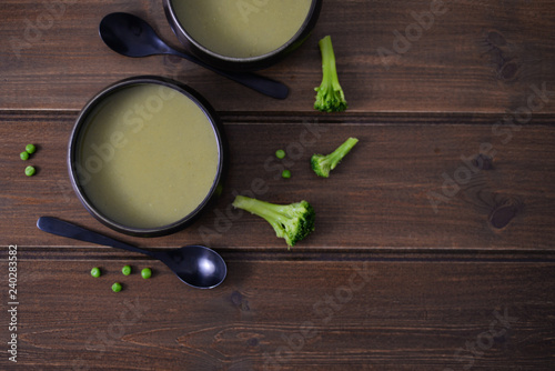 green vegetables pure soup with broccoli green pea and Dwarf cabbage on brown rustic wooden table 