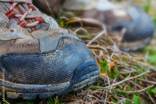 closeup touristic boots in a grass