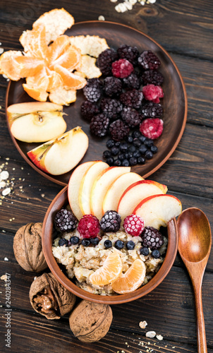 oatmeal with fruit on a wooden background photo