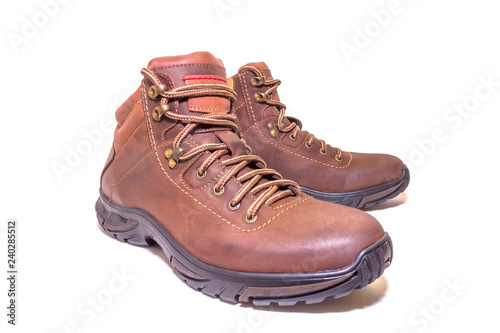 Brown winter boots with genuine leather laces on a white isolated background