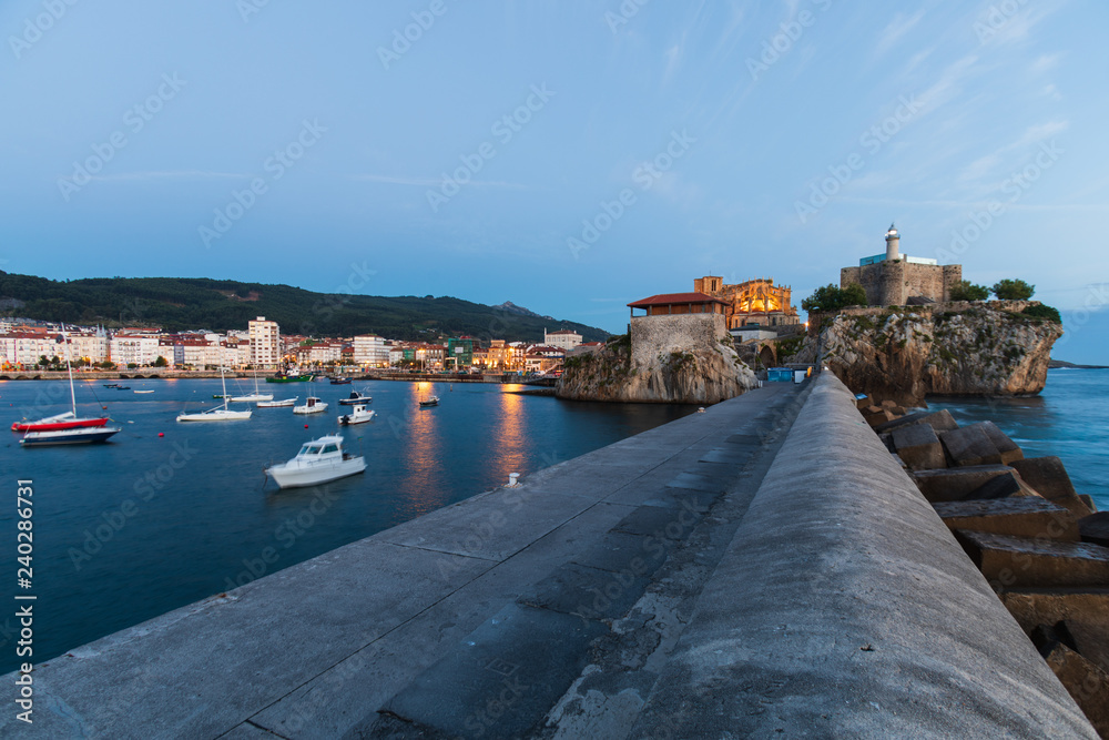 The lighthouse and the church of Santa Maria in the beautiful port of Castro Urdiales, Cantabria, before sunrise